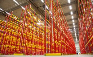 huge warehouse inside with empty racks in red